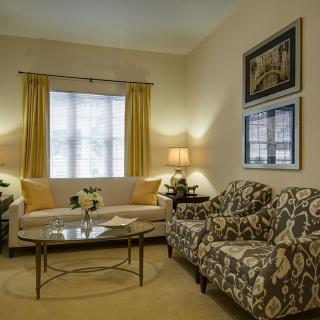 A cozy living room with stylish furnishings and warm lighting.