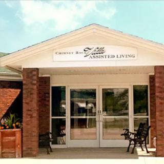 The entrance to an assisted living facility with a brick exterior.