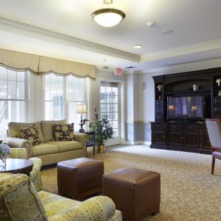 A cozy living room with comfortable seating and a large television.