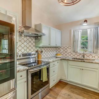 Modern kitchen with stainless steel appliances and stylish backsplash.