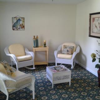 Cozy living room with wicker furniture and decorative elements.