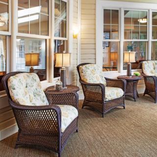 A cozy indoor patio with wicker chairs and soft lighting.