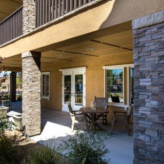 A modern outdoor patio area featuring stone and wood elements, perfect for relaxation.