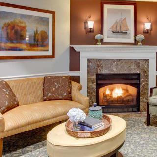 Cozy living room with a warm fireplace and elegant decor.