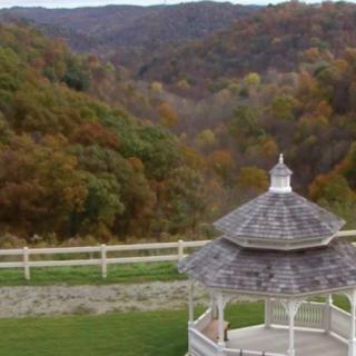 A scenic view of a gazebo overlooking autumn-colored hills.