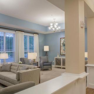 A modern living room with elegant decor and neutral colors.