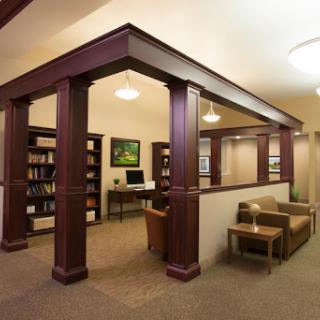 A cozy and modern library with comfortable seating and well-stocked bookshelves.