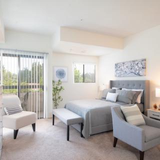 A bright and modern bedroom with elegant decor and natural light.