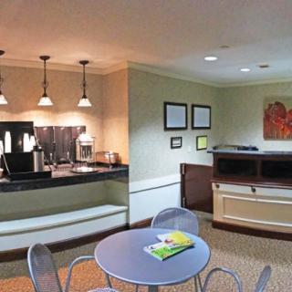 A cozy lobby area with a coffee station and seating arrangements.