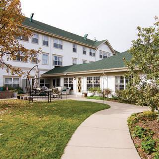 A well-maintained outdoor area with a pathway leading to a multi-story building.