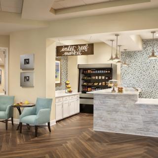 A modern cafe interior with a cozy seating area and stylish counter.