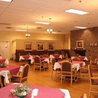 An empty dining room with neatly arranged tables and chairs, set for service.