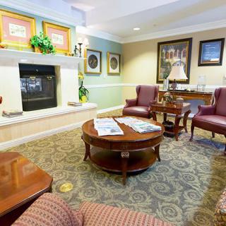 A cozy living room with elegant furniture and a warm fireplace.