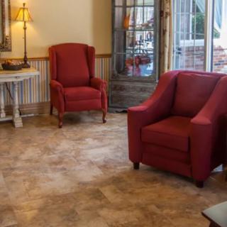 A cozy living room featuring red chairs and warm lighting.