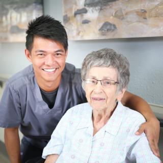 A caregiver smiling with an elderly woman, highlighting senior care and support.