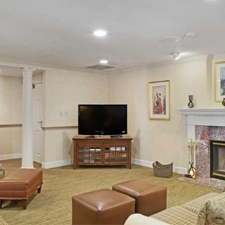 A cozy living room with a television, fireplace, and modern furniture.