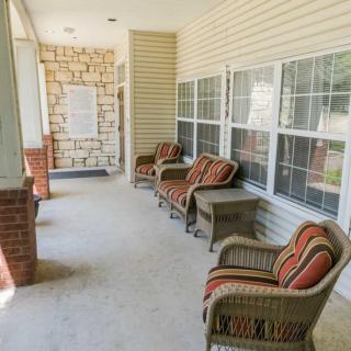 A cozy porch with wicker chairs and colorful cushions, perfect for relaxation.