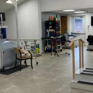 A physical therapy room equipped with various rehabilitation tools and exercise equipment.