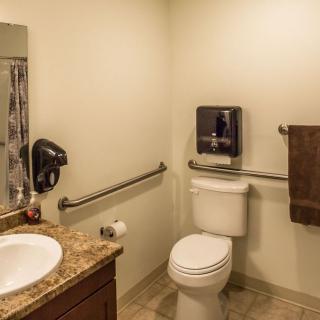 A clean and accessible bathroom with safety rails.