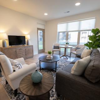 A beautifully designed living room featuring modern furniture and plenty of natural light.