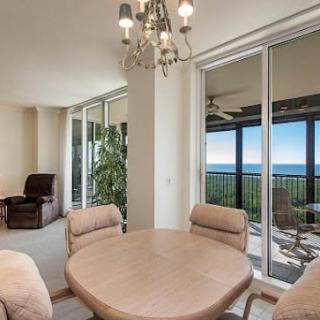 A modern dining area with sliding doors offering a stunning ocean view.