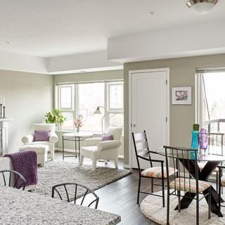 A modern living and dining area with natural lighting, featuring stylish furniture and a contemporary design.