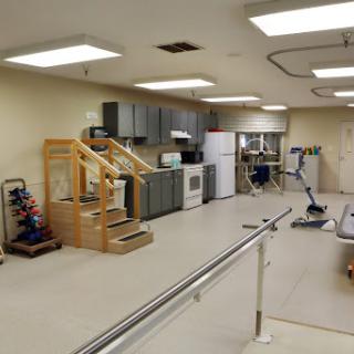 A rehabilitation therapy room equipped with stairs and various exercise apparatus.