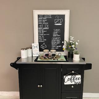 A stylish coffee station complete with a chalkboard menu and decorative plants.