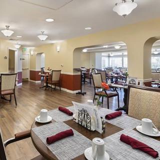 A well-appointed dining area featuring neatly set tables and comfortable seating.