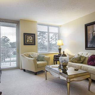 A cozy living room with elegant furnishings and artwork.