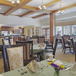 An elegant dining room with neatly set tables and comfortable chairs.