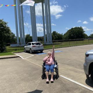 A joyful moment captured under a sunny sky with a remarkable landmark in the background.