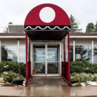 Entrance to a restaurant with a red awning.