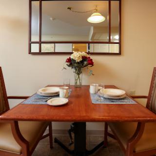 A beautifully set dining table with a floral arrangement and elegant dinnerware, reflecting a cozy dining atmosphere.