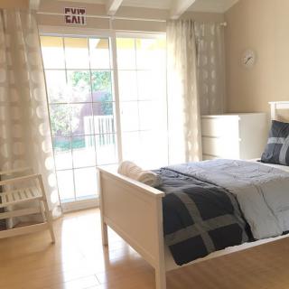 A bright and minimalist bedroom with a large window letting in natural light.