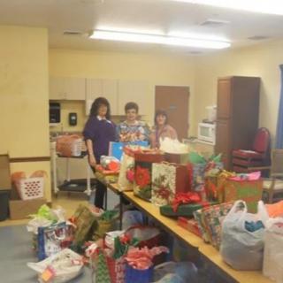 Volunteers organizing and wrapping donated gifts for a charity event.
