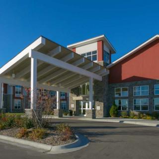 A modern building with a covered entrance on a clear day.