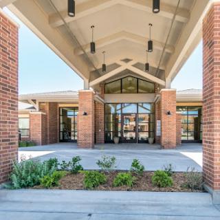 A modern building entrance featuring a spacious canopy and contemporary architectural design.