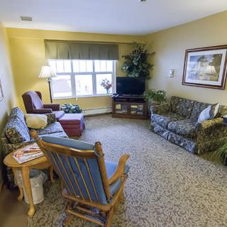 A cozy living room with comfortable seating and a television.