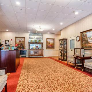 A well-lit lobby with elegant furniture and artwork adorning the walls.