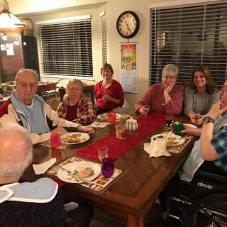 A family gathered around a dinner table sharing a meal.