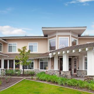A modern residential house with a landscaped yard and contemporary architectural design.