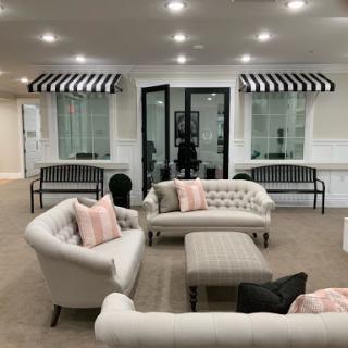 A stylish and modern living room setup featuring elegant seating and ambient lighting.