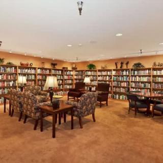 A cozy library with bookshelves and a comfortable seating area.