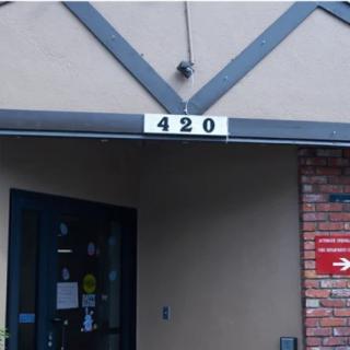 A building entrance with the address number '420' displayed above the door.