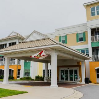 A modern building with a prominent entrance canopy.