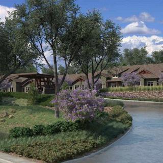 A tranquil landscape featuring a gently flowing river bordered by lush greenery and blooming flowers.