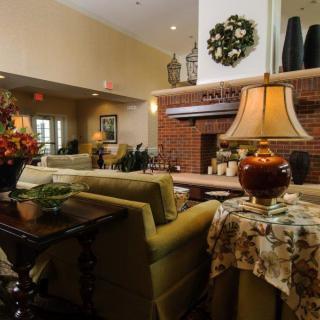 A cozy living room with a brick fireplace and warm lighting.