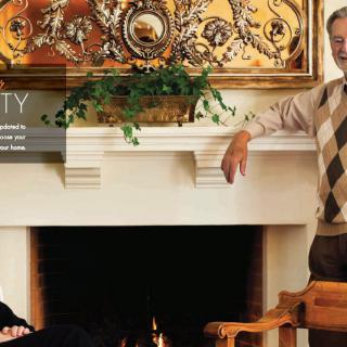 Two people relaxing by a decorated fireplace in a cozy home setting.