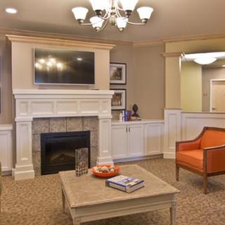 A cozy living room with a fireplace and modern decor.